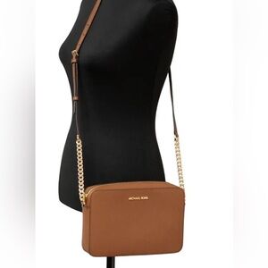 Michael Kors authentic tan leather Crossbody jet set Bag with Gold Accents.